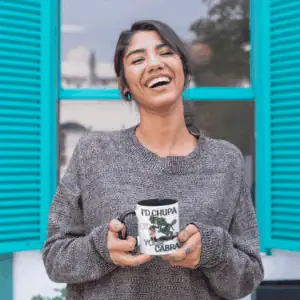 woman holding chupacabra cryptid coffee cup