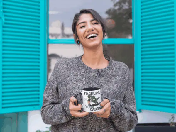 woman holding chupacabra cryptid coffee cup